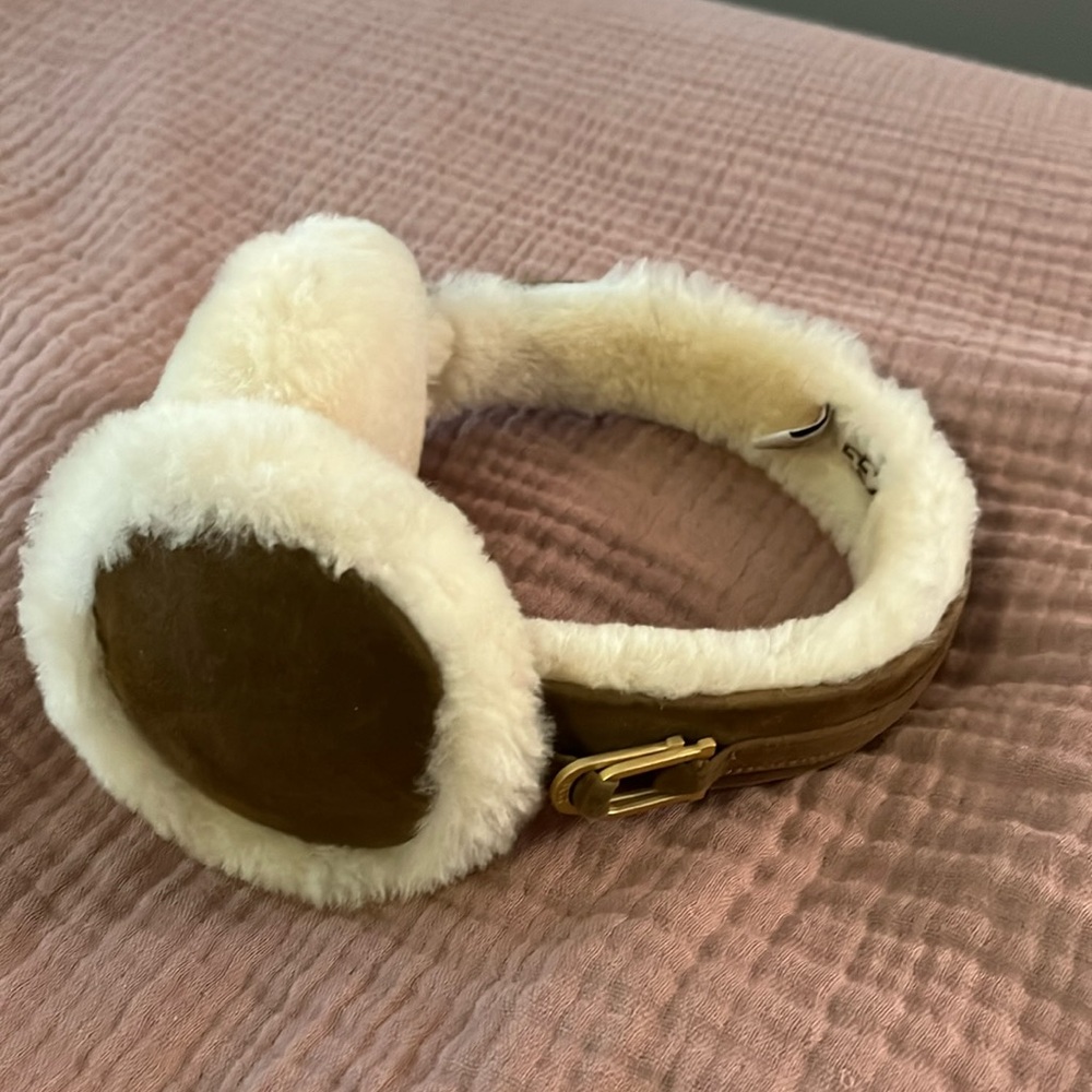 Genuine shearling earmuffs defined by a suede band and logo hardware